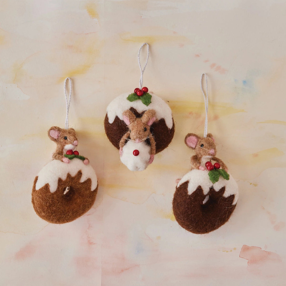 The CREATIVE COOP HANDMADE FELT MOUSE ON DOUGHNUT features a charming wool felt mouse with pink ears sitting atop a chocolate doughnut ornament decorated with holly. Set includes three handmade ornaments.