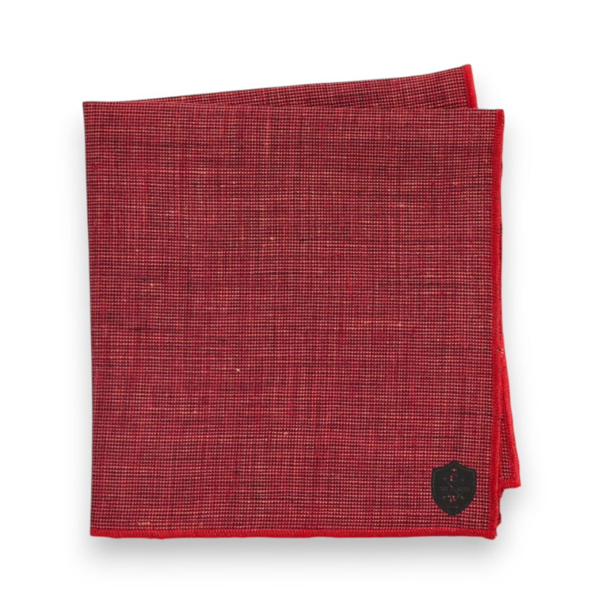 The CLIFTON WILSON Dark Red Linen Pocket Square features a subtle checked pattern and a small black shield emblem in the corner, made in the USA and shown against a white background.