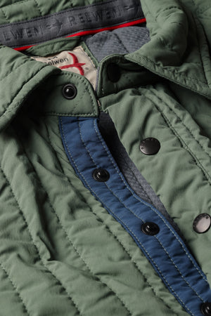 The RELWEN Polo-Jack in Muted Olive, a long-sleeve quilted technical popover featuring a chest pocket, buttoned collar, and cuffs, is shown laying flat on a white background.