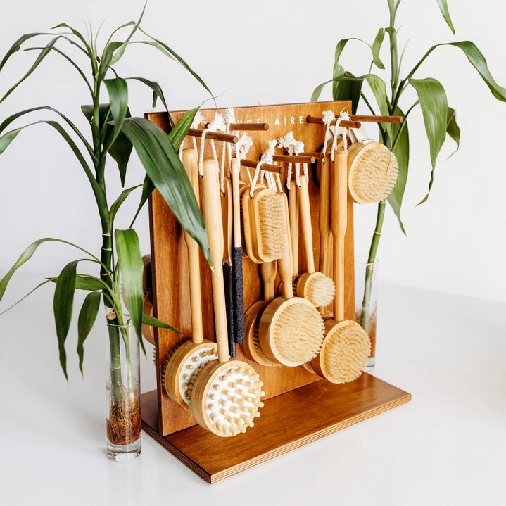 The BAUDELAIRE - BAMBOO 4” NAIL BRUSH by BAUDELAIRE, featuring stiff, light-colored natural boar bristles and a looped rope handle, is displayed on a plain white background.