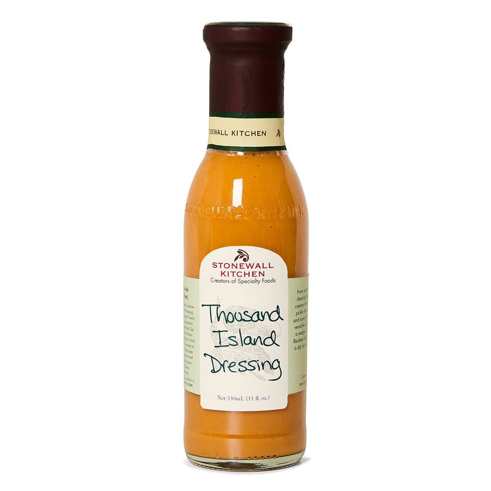 A bottle of STONEWALL KITCHEN - THOUSAND ISLAND DRESSING by STONEWALL KITCHEN, ideal for Reuben sandwiches or as a gourmet salad dressing, featuring an orange label and maroon cap, is displayed upright against a white background.