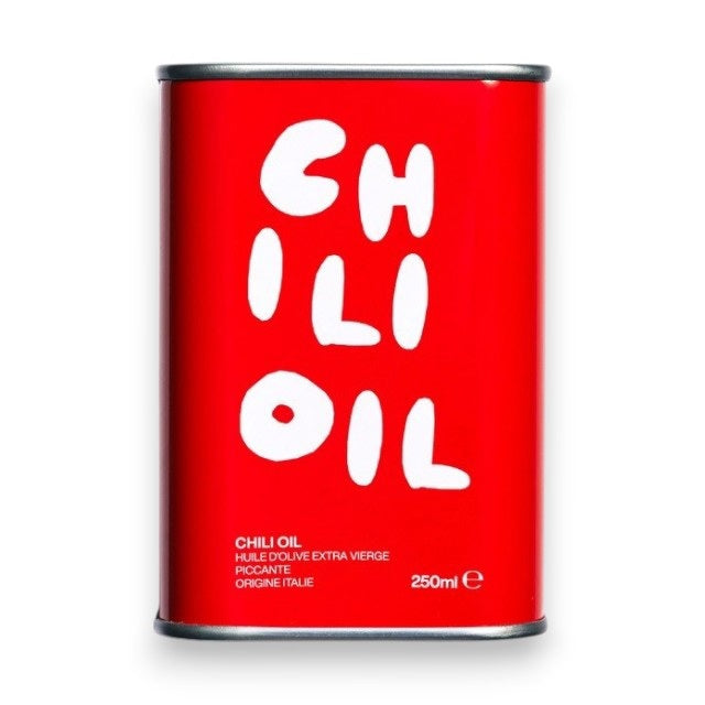 A 250ml red tin of OLEA PIA - CHILI OIL, made with extra virgin organic olive oil from Italy, is perfect as a spicy pizza oil. The bold white label features the product name, and the tin is shown against a plain white background.