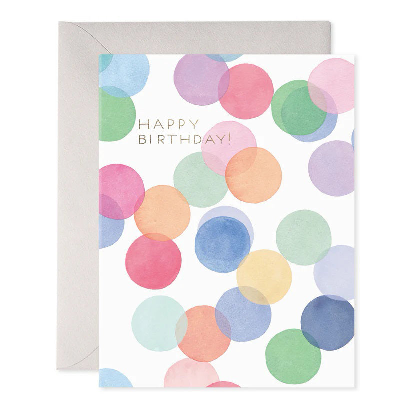 The E. FRANCES PAPER - Falling Confetti Birthday Card from E. FRANCES PAPER showcases handcrafted, overlapping translucent circles in pink, blue, green, and yellow with "Happy Birthday!" in gold on a white background. Made with luxurious paper, it includes a sleek gray envelope ideal for any collection.