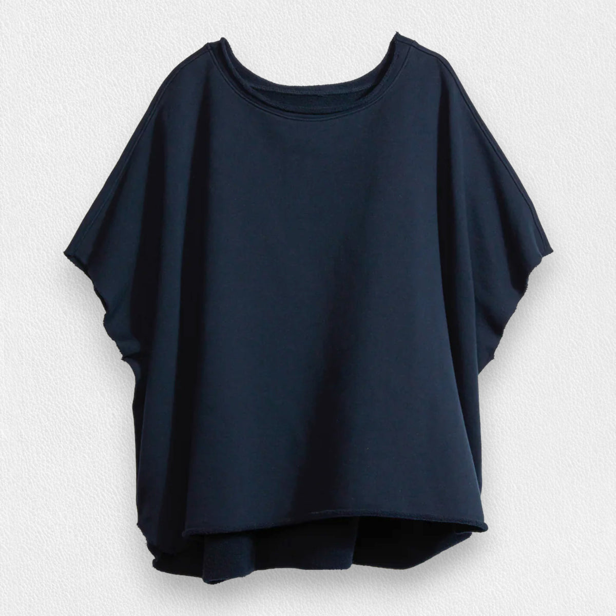 A loose-fitting, short-sleeved navy t-shirt by FRANK &amp; EILEEN features a round neckline and 100% cotton material, set against a light textured background. The FRANK AND EILEEN - OLIVE ORIGINAL CAPELET IN BRITISH ROYAL NAVY has a slightly curved hem for a relaxed silhouette.