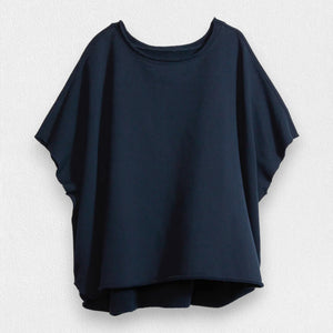 A loose-fitting, short-sleeved navy t-shirt by FRANK & EILEEN features a round neckline and 100% cotton material, set against a light textured background. The FRANK AND EILEEN - OLIVE ORIGINAL CAPELET IN BRITISH ROYAL NAVY has a slightly curved hem for a relaxed silhouette.