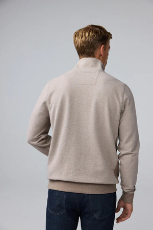 A man wearing a tan Mack Weldon ACE QUARTER ZIP French terry pullover with ribbed cuffs and hem.