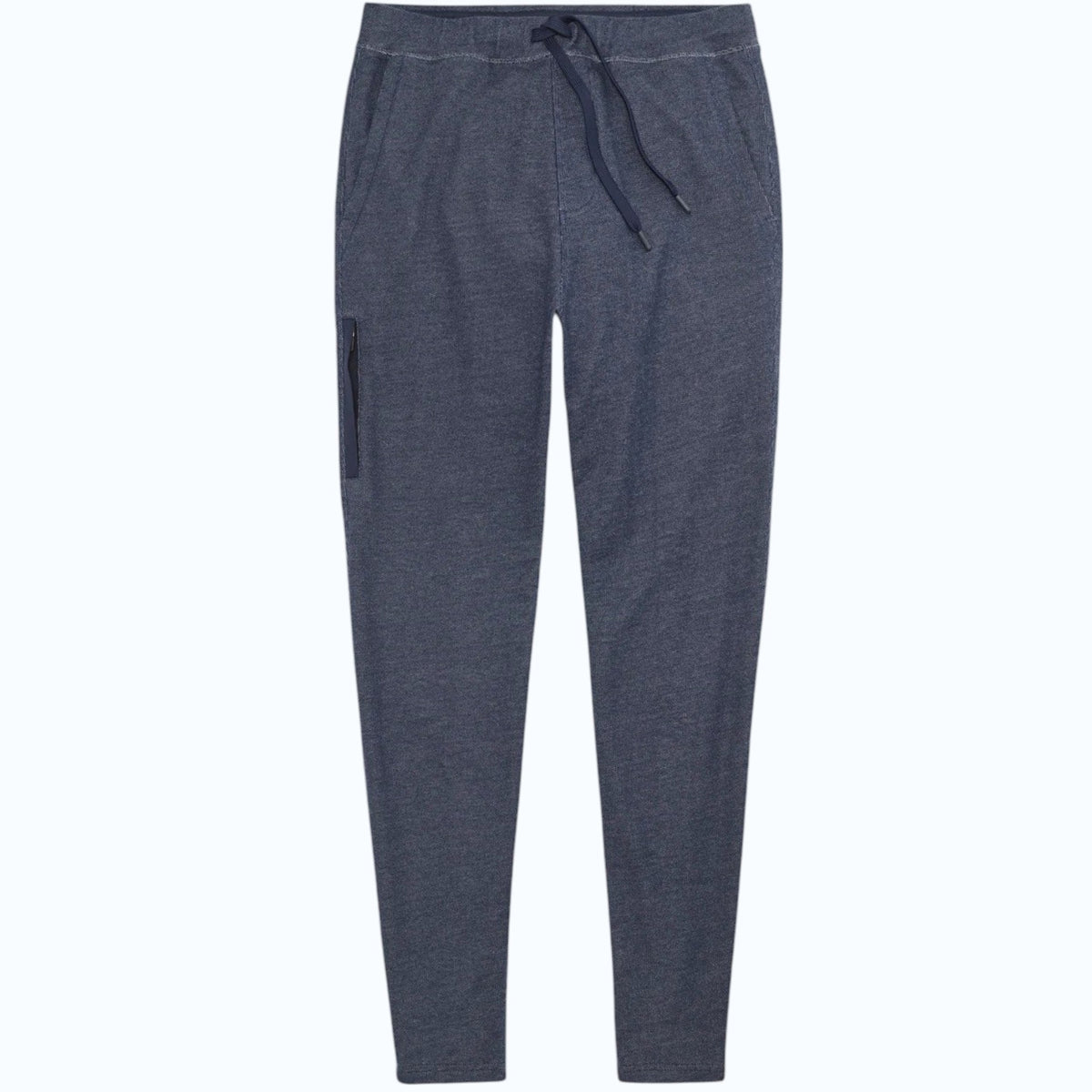 Close-up of a person wearing MACK WELDON Ace Sweatpants in True Navy Bird’s Eye with a tailored fit, drawstring waist, and pockets—one hand in the front pocket—paired with a dark blue shirt.