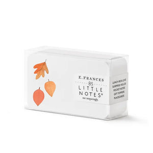 Three small E. FRANCES - LITTLE NOTES FALLING LEAVES notecard stacks by E. FRANCES PAPER, featuring autumn leaf illustrations, are shown with a yellow pencil; one stack says "FRONT," another "BACK," and one is in packaging labeled "LITTLE NOTES.