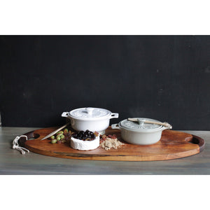 Set of two CREATIVE COOP stoneware brie bakers with lids—one gray, one white—each featuring handles and a matching wooden spreader tied on top.