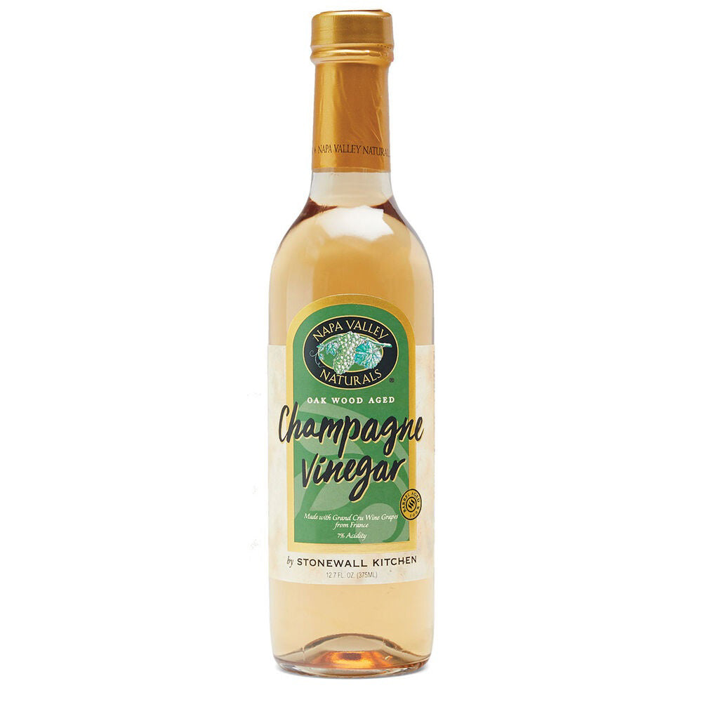 A 12.7 fl. oz. bottle of Stonewall Kitchen - Champagne Vinegar made with grapes from Grand cru-rated vineyards. The bottle features a gold cap and a label with green, beige, and gold detailing, displaying the brand name and product information.