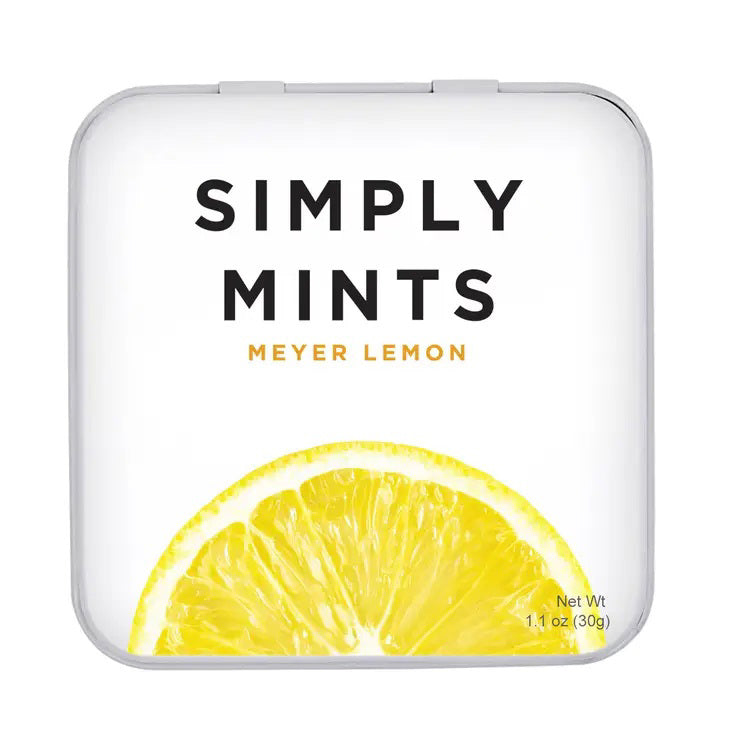 A square tin container of Meyer Lemon Mints from Simply Gum is shown. The lid features the product name "Simply Gum" in large black letters with "Meyer Lemon Mints" in smaller yellow letters beneath it. A vibrant yellow lemon slice is depicted at the bottom, and there are no artificial sweeteners.
