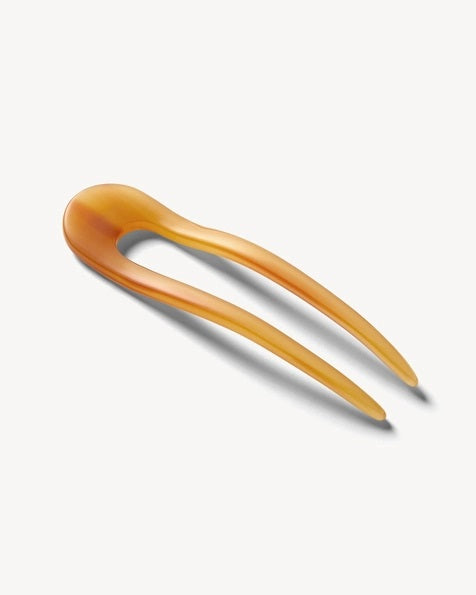 A smooth, black MACHETE - FRENCH HAIR PIN with two prongs, crafted from Italian acetate by MACHETE, rests on a plain white surface.