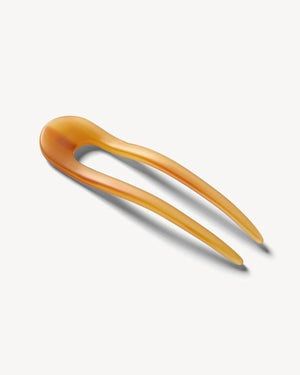 A smooth, black MACHETE - FRENCH HAIR PIN with two prongs, crafted from Italian acetate by MACHETE, rests on a plain white surface.