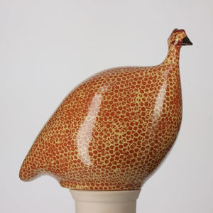 Illustration showing three differently sized bird figurines, from the collection LES CERAMIQUES DE LUSSAN by the brand LES CERAMIQUES DE LUSSAN, reminiscent of a French brood, lined up by height next to a mug labeled "MUG." The largest bird is 24 cm (LARGE CERAMIC FRENCH GUINEA IN TERRACOTTA RED SPOTTED YELLOW), the medium bird is 20 cm, and the smallest bird (including a pecking model) is 17 cm. The mug's height is 8.5 cm.