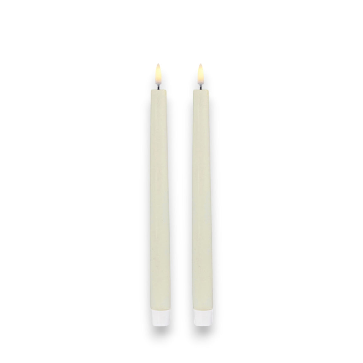 On a plain white background, two ivory UYUNI taper candles by PIFFANY stand lit side by side. Their simple white bases enhance the warm ambiance, creating a subtle yet exquisite luxury setting.