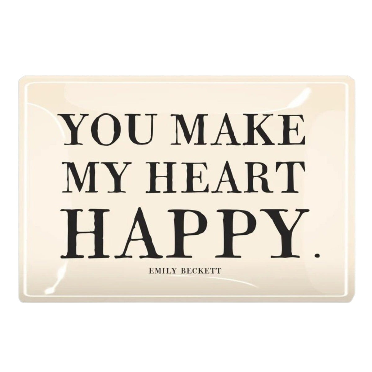 A cream-colored glass tray from BENS GARDEN features bold black lettering that reads, "YOU MAKE MY HEART HAPPY," with "EMILY BECKETT" inscribed below in smaller print. Reminiscent of the handcrafted style Ben’s Garden is known for, the BEN’S GARDEN - YOU MAKE MY HEART HAPPY DECOUPAGE GLASS TRAY makes a thoughtful gift or a charming accent for any space.
