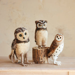 Three HANDMADE WOOL FELT BARN OWL, BROWN figures of varying sizes displayed on a wooden surface as festive Christmas decor.
