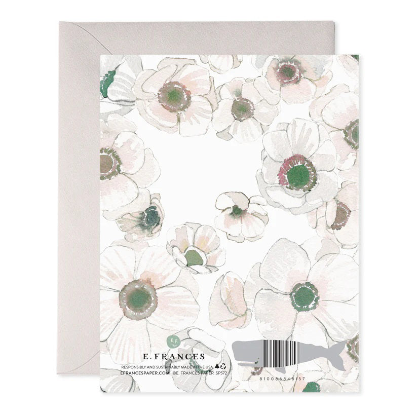 The E. FRANCES PAPER - WHITE FLOWER WEDDING CARD features watercolor-style white flowers with "Congrats on your wedding" in elegant gold lettering on the front, capturing the charm of an artisanal greeting card. An envelope peeks from behind it.