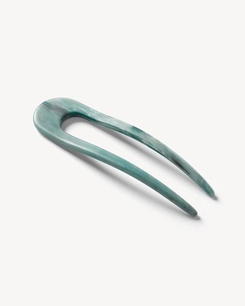 A smooth, black MACHETE - FRENCH HAIR PIN with two prongs, crafted from Italian acetate by MACHETE, rests on a plain white surface.