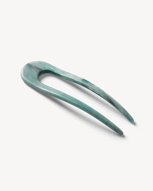 A smooth, black MACHETE - FRENCH HAIR PIN with two prongs, crafted from Italian acetate by MACHETE, rests on a plain white surface.
