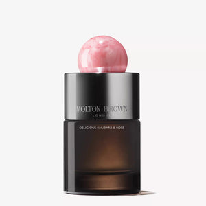 A bottle of MOLTON BROWN - RHUBARB & ROSE EAU DE PARFUM, featuring a matte black body and a round marbled pink cap, displayed against a plain white background.
