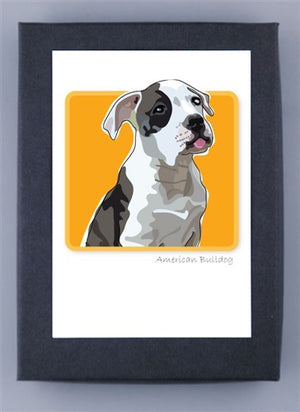 A whimsical illustration of an American Bulldog puppy with a black and white coat is depicted on a vibrant yellow background. The puppy, sitting adorably and gazing slightly to the side with its tongue playfully sticking out, is complemented by the text "American Bulldog" underneath. This charming design is printed on FSC certified recycled paper and comes elegantly framed, making it a delightful feature of PAPER RUSSELLS' AMERICAN BULLDOG NOTE CARDS collection.