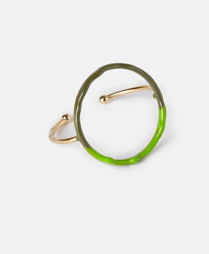 The DIP DYE BRACELET by MOMONI is a uniquely designed artisanal piece, featuring an enamelled metallic golden band with a round, circular structure. The bracelet showcases an elegant combination of half brown and half light blue hues, boasting an irregular, organic shape and minimalist style, set against a plain white background.