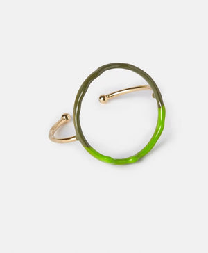 The DIP DYE BRACELET by MOMONI is a uniquely designed artisanal piece, featuring an enamelled metallic golden band with a round, circular structure. The bracelet showcases an elegant combination of half brown and half light blue hues, boasting an irregular, organic shape and minimalist style, set against a plain white background.
