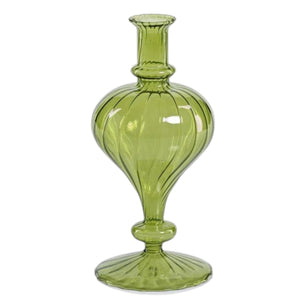 Five green glass vases, including the VENETIAN SPIRAL VASE IN GREEN TURNIP SHAPE by ZODAX and a decorative vase, each with unique shapes and textures, are arranged on a reflective gold tray. Two of the vases are adorned with decorative red berry branches. The softly lit background remains neutral.