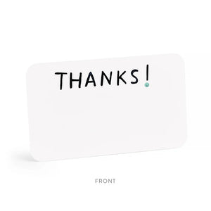 A clear plastic box contains E. Frances Paper - Thanks Little Notes, each decorated with "THANKS!" on the cover. These charming cards showcase a subtle watercolor design, encouraging generous use for any occasion.