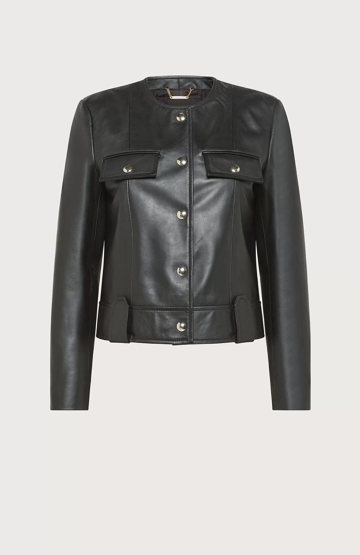 The SEVENTY - SOFT NAPA LEATHER CREWNECK JACKET by SEVENTY is a black leather jacket with a round collar and long sleeves. Made in Italy, it boasts a row of gilded buttons down the front, two buttoned chest pockets, and decorative belt loops at the waist. The design is sleek and minimalist, providing a modern, edgy look.