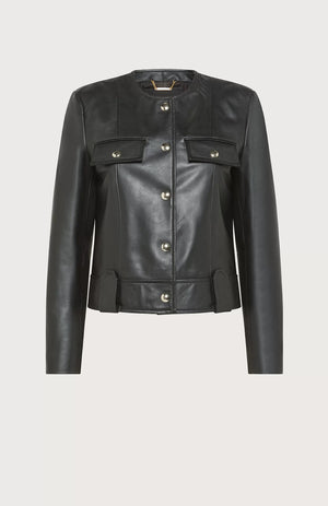 The SEVENTY - SOFT NAPA LEATHER CREWNECK JACKET by SEVENTY is a black leather jacket with a round collar and long sleeves. Made in Italy, it boasts a row of gilded buttons down the front, two buttoned chest pockets, and decorative belt loops at the waist. The design is sleek and minimalist, providing a modern, edgy look.