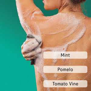 A teal tube labeled “AKT - BODY WASH CONCENTRATE HALCYON SUMMERS” from AKT LONDON, a microbiome-friendly and concentrated body wash, stands in front of its matching box on a beige surface with soft shadows in the background.