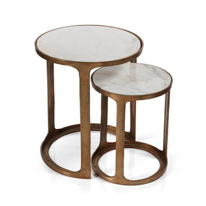 The ZODAX NIKKI Round Marble and Alloy Nesting Tables feature white marble tops and gold frames. Perfect for chic living rooms, the smaller table partially tucks under the larger one, offering style and space-saving versatility on any wooden floor.