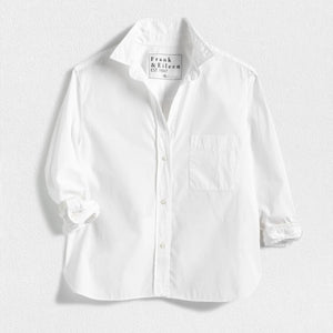 The FRANK & EILEEN Silvio Untuckable Button-Up Shirt in Superluxe Cotton, featuring a chest pocket and rolled-up sleeves, is laid flat on a textured surface. The inside label reads "Frank & Eileen EST 1947.