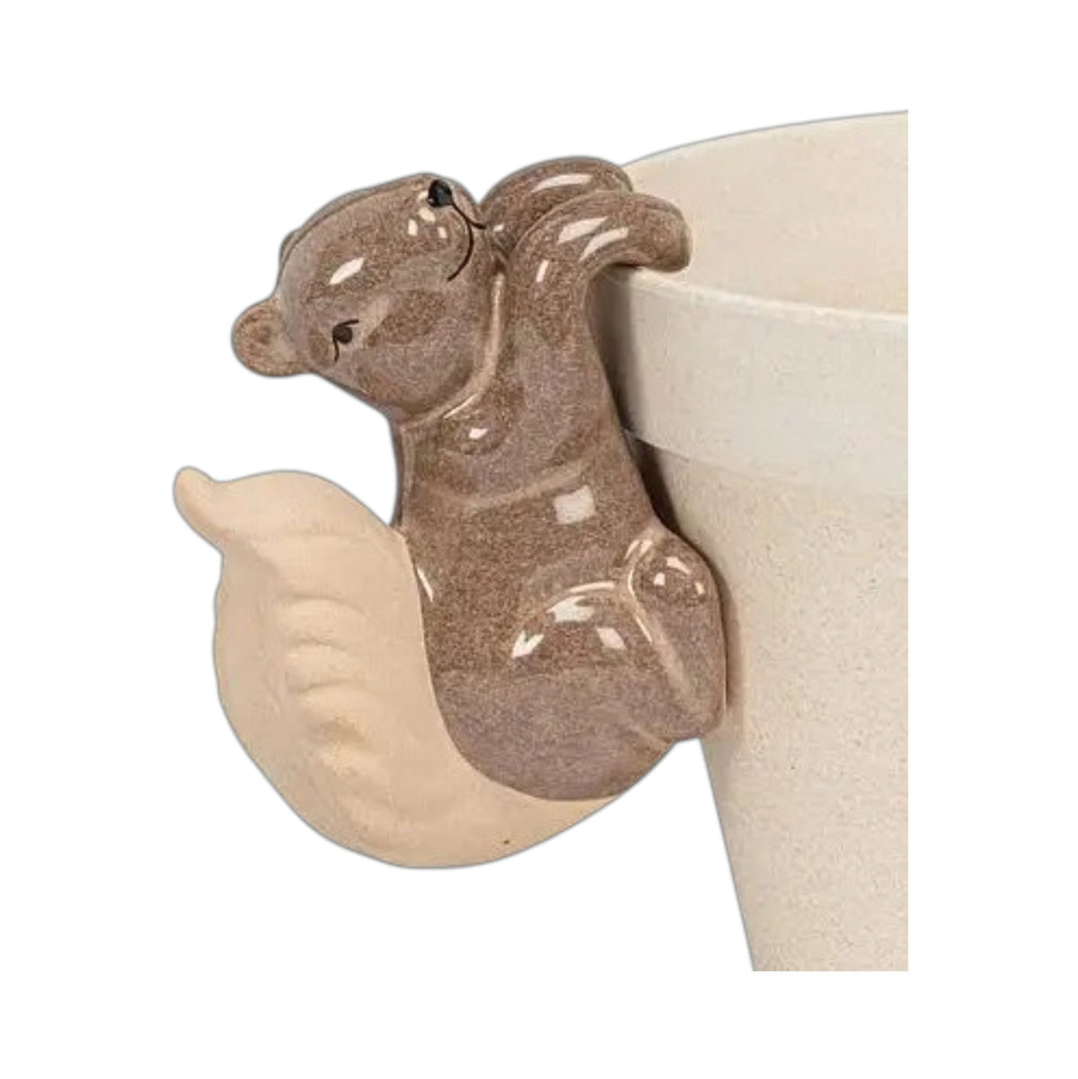A brown ceramic CLIMBING SQUIRREL POT HANGER by ABBOTT perched on the rim of a planter.