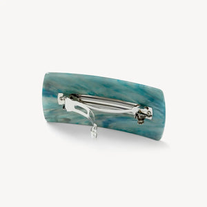 The MACHETE Jumbo Box Barrette in Jadeite is a rectangular hair clip made from Italian acetate with a marbled teal, blue, and white pattern—a bold accessory showcased on a plain white background.