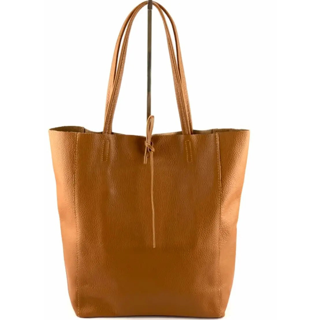 The LEATHER TOTE BAG IN CAMEL by JIJOU CAPRI is a large Italian leather tote with double handles, an unstructured shape, and a slim leather tie at the top. Made in Italy, shown against a white background.