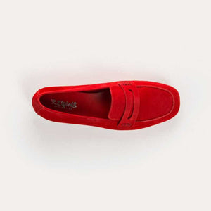 The REQINS HEMA Suede Loafer in Rouge features bright red suede, low heels, a classic penny loafer design, and a supple leather insole—all crafted with artisanal expertise and shown on a plain light background.