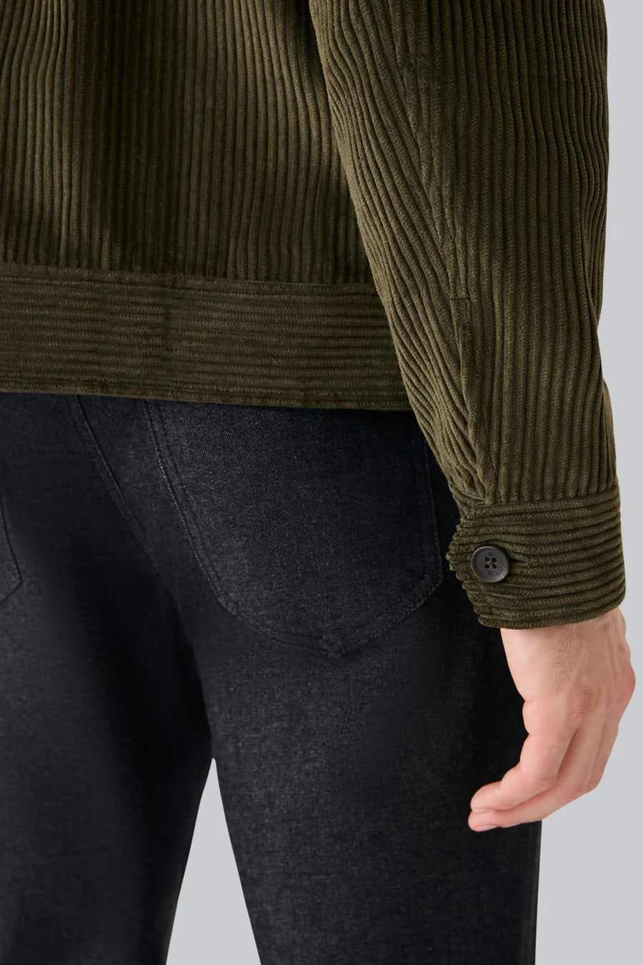 The MACK WELDON - CORDUROY ZIP JACKET is a modern-fit, dark blue corduroy jacket with a front zipper, long sleeves, collar, and chest pocket—shown against a white background.