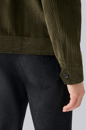 The MACK WELDON - CORDUROY ZIP JACKET is a modern-fit, dark blue corduroy jacket with a front zipper, long sleeves, collar, and chest pocket—shown against a white background.