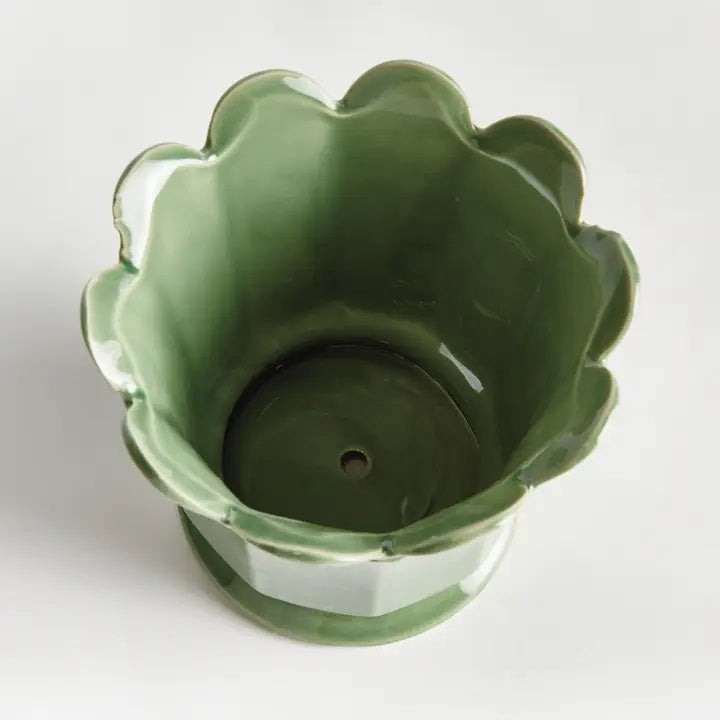 The NAPA HOME AND GARDEN Maline Footed Pot in Green, Large, features a light green ceramic finish with a scalloped, petal-like rim and a flared, rounded base. This elegant vase by NAPA HOME AND GARDEN is photographed against a plain white background.