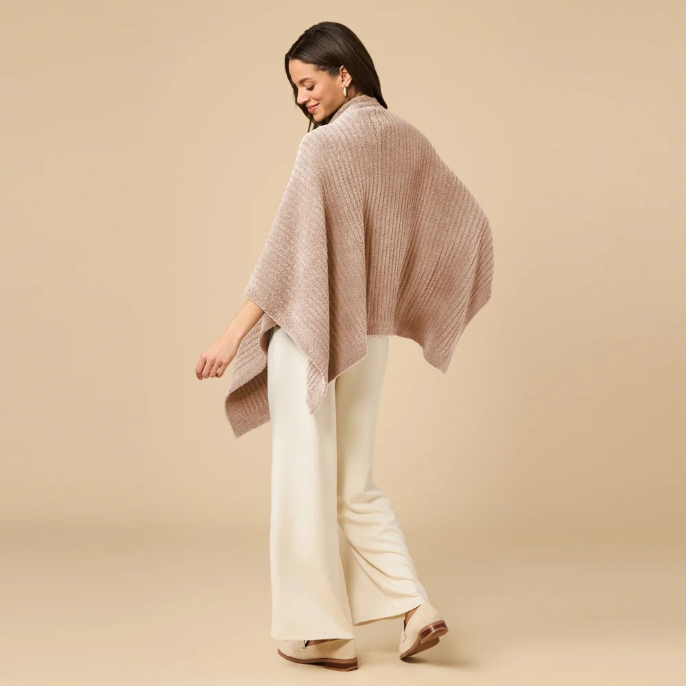 A woman wearing a black SOFTIES - SOLID RIB MARSHMALLOW SHAWL over a grey top and white trousers.