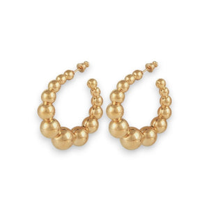 The GAS BIJOUX - ANDY CREOLE EARRING features gold plated hoops embellished with graduated spherical beads for a sophisticated, textured appearance. The hoops boast a shiny finish and are symmetrically arranged to elevate their chic design, all set against a plain white background.