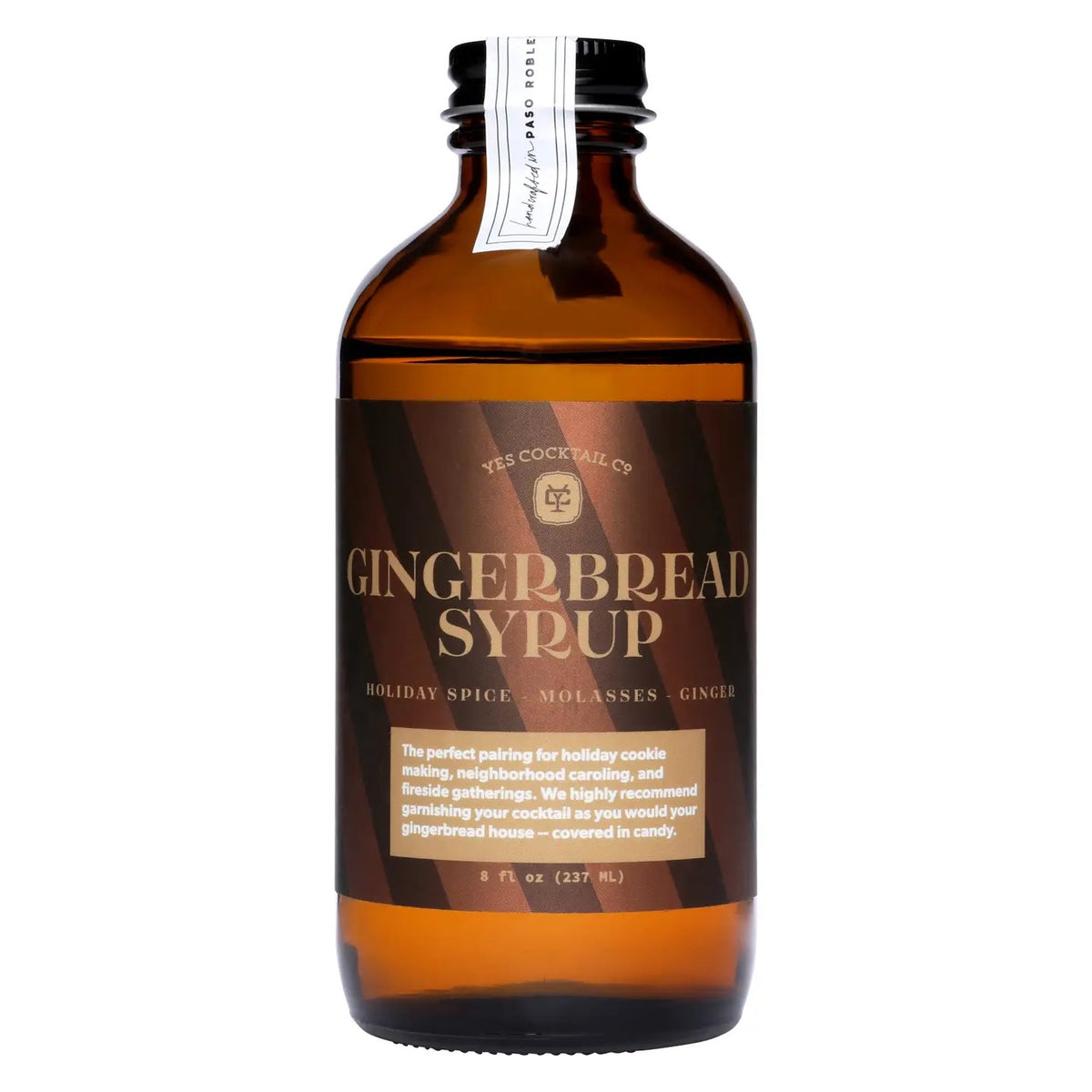 A brown glass bottle labeled “YES COCKTAIL CO - GINGERBREAD SYRUP” from YES COCKTAIL CO., featuring gold and white text and a description of holiday spice, molasses, and ginger. This all-natural holiday syrup is ideal for festive drinks or desserts and comes in an 8 fl oz (237 mL) bottle.