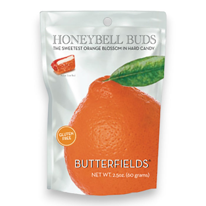 A white bag of BUTTERFIELDS - HONEYBELL ORANGE BUDS hard candy by BUTTERFIELDS, featuring a Florida Orange with a green leaf. The 2.5 oz (60g) packaging notes the candy is gluten-free.