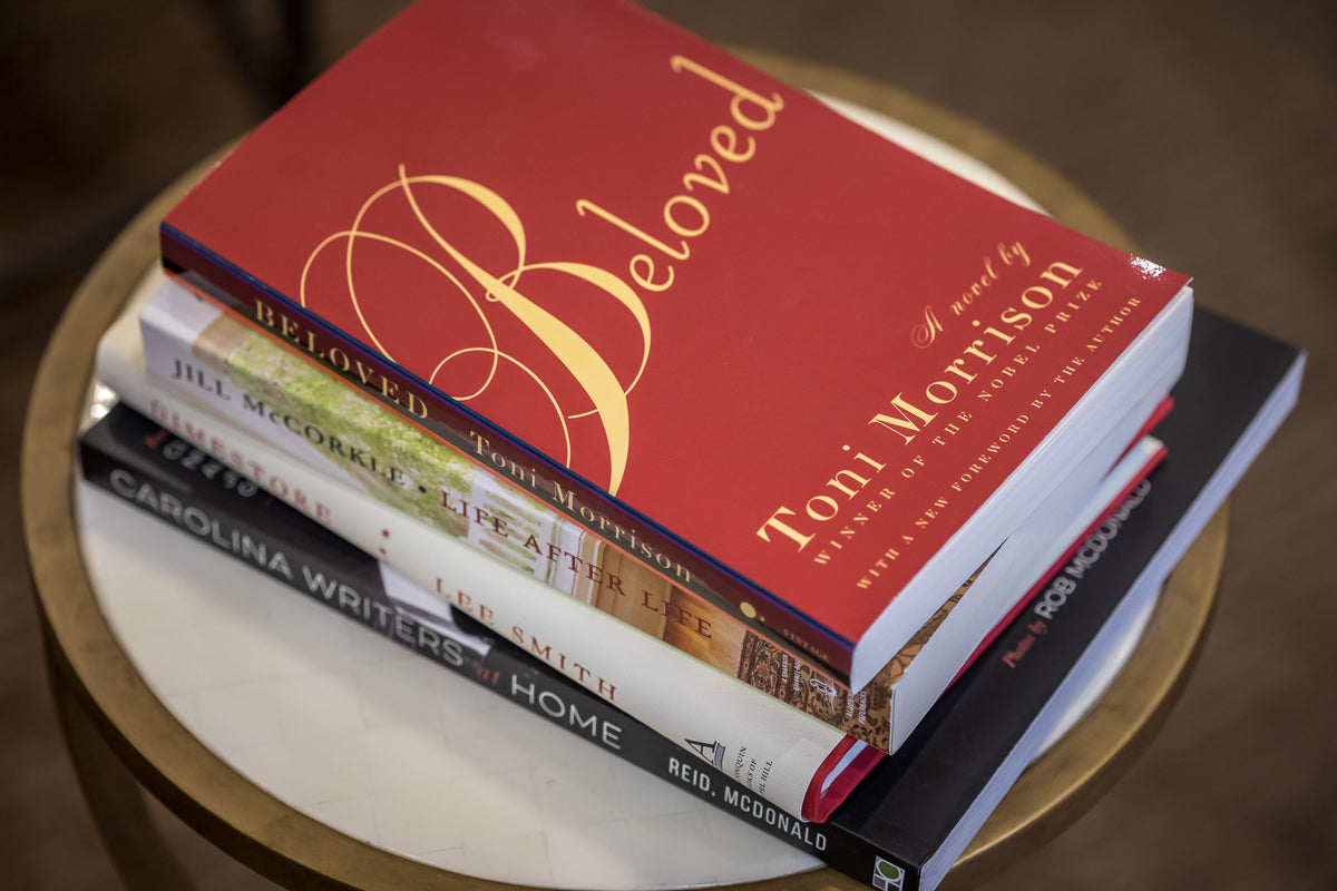 A stack of five books on a round table, with 