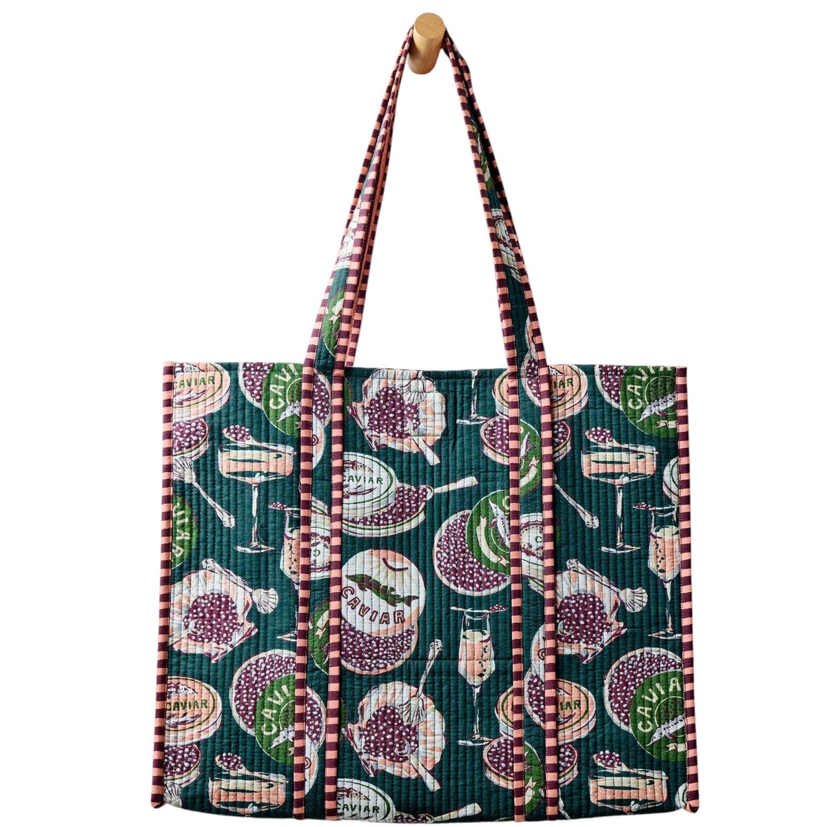 Discover a repeating pattern of caviar tins, open shells filled with caviar, mini forks, and champagne glasses set against a deep green background—an elegant design featured on the PRINTFRESH - CHAMPAGNE & CAVIAR TRAVELER TOTE by PRINTFRESH.