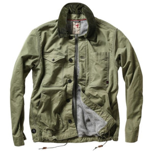 The RELWEN Pile-Lined Chore Coat in Palm Green is a stylish workwear jacket with a green quilted sleeve, olive-green collar and cuffs, and a soft gray fleece body with rugged lining, shown lying open on a white background.