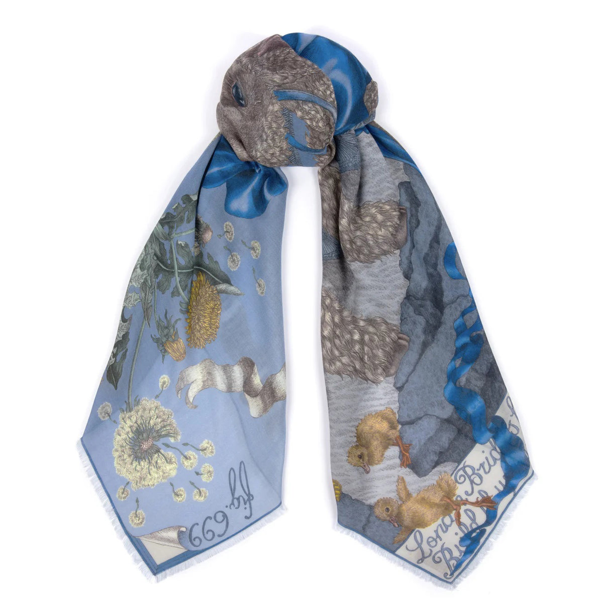 The SABINA SAVAGE ENGLAND cashmere scarf, named "London Bridge is Falling Down," displays intricate nature-themed illustrations of rabbits, flowers, and baby lambs on a light blue background. Tied in a loose knot, the scarf beautifully highlights its detailed patterns.